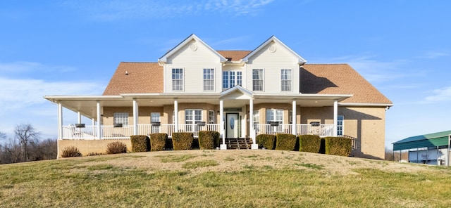 view of front of property with a front yard and covered porch