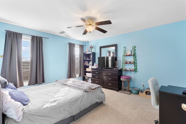 bedroom featuring ceiling fan and light carpet