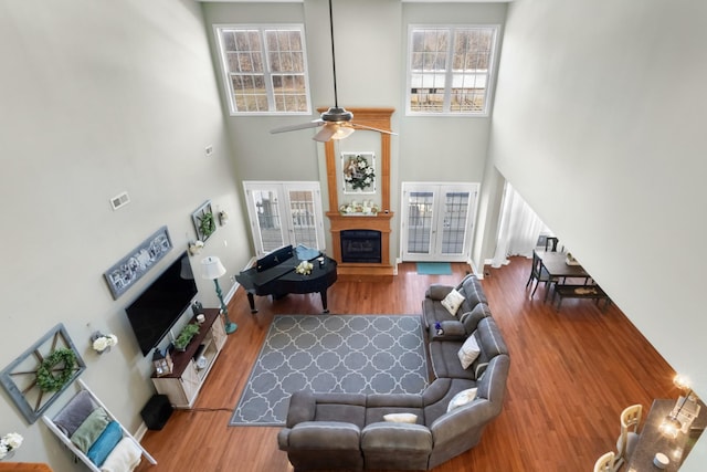 living room with hardwood / wood-style floors, french doors, and a high ceiling