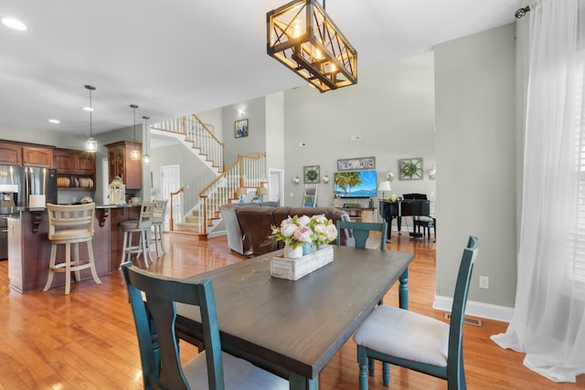 dining space featuring a notable chandelier and light hardwood / wood-style floors