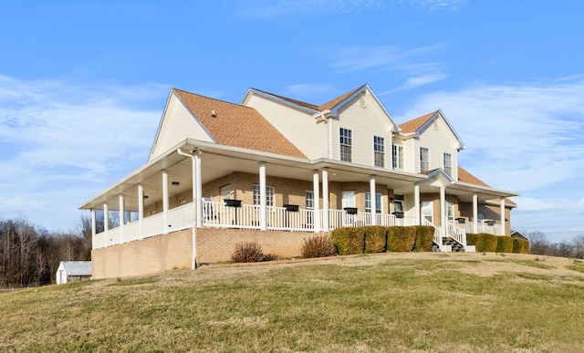 view of property exterior featuring covered porch and a lawn