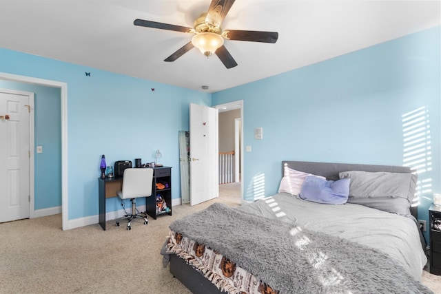 bedroom with ceiling fan and light carpet