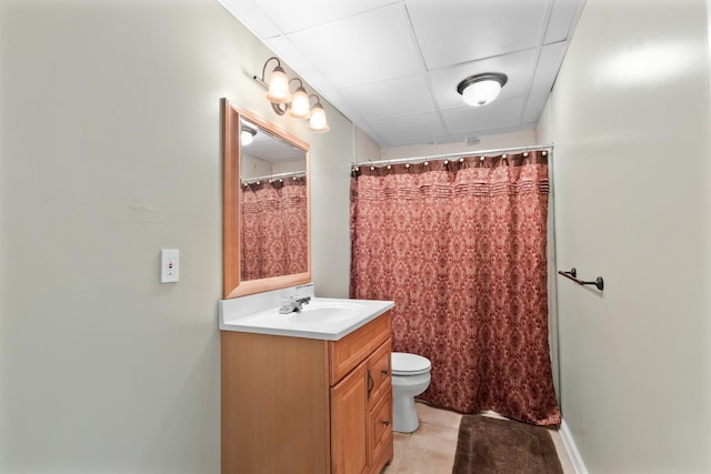 bathroom featuring tile patterned floors, toilet, a paneled ceiling, vanity, and a shower with shower curtain