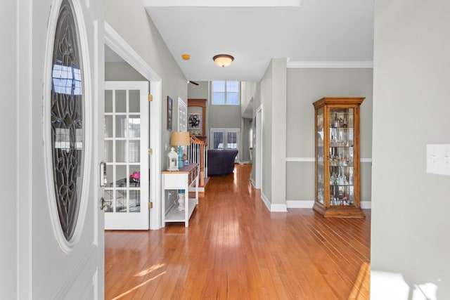 entrance foyer featuring hardwood / wood-style flooring and ornamental molding