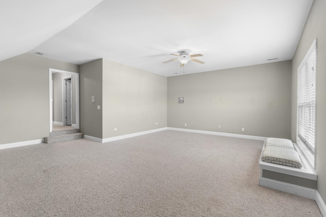 carpeted spare room with plenty of natural light and ceiling fan