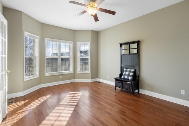 empty room with wood-type flooring and ceiling fan