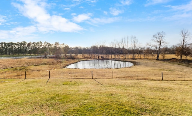 view of pool with a rural view, a lawn, and a water view