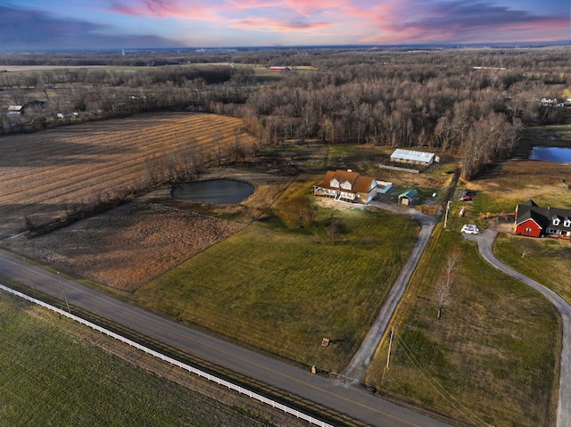 aerial view at dusk featuring a rural view