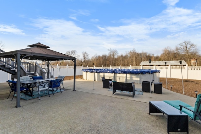 view of patio / terrace featuring a gazebo and a covered pool