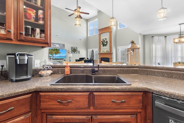 kitchen featuring pendant lighting, ceiling fan, dishwasher, and sink