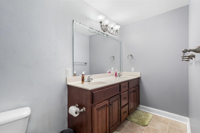 bathroom featuring vanity, tile patterned floors, and toilet