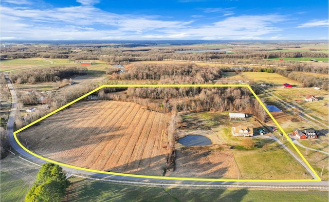 birds eye view of property with a rural view