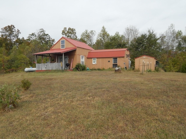 view of front of house with a storage shed and a front yard