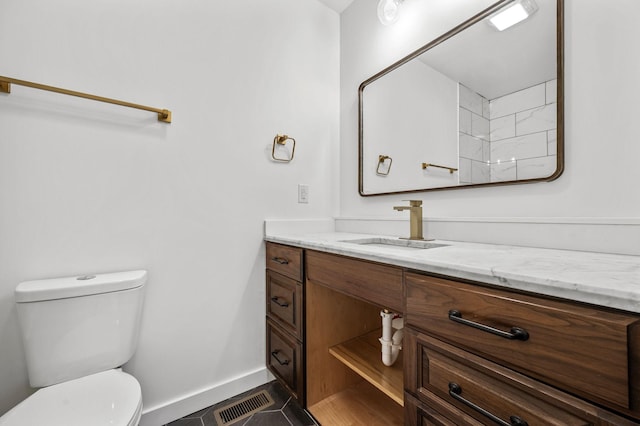 bathroom with tile patterned floors, vanity, and toilet