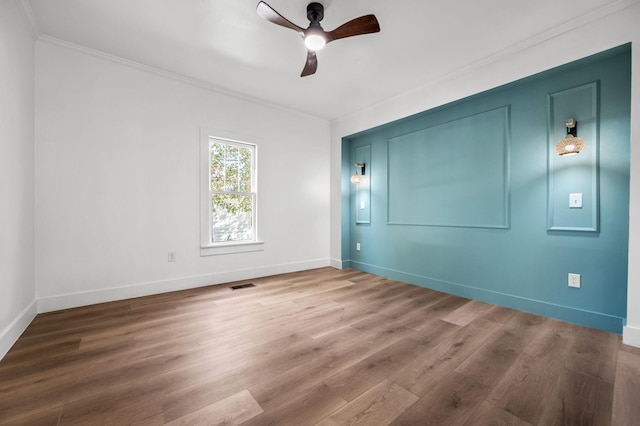 unfurnished room with crown molding, hardwood / wood-style flooring, and ceiling fan