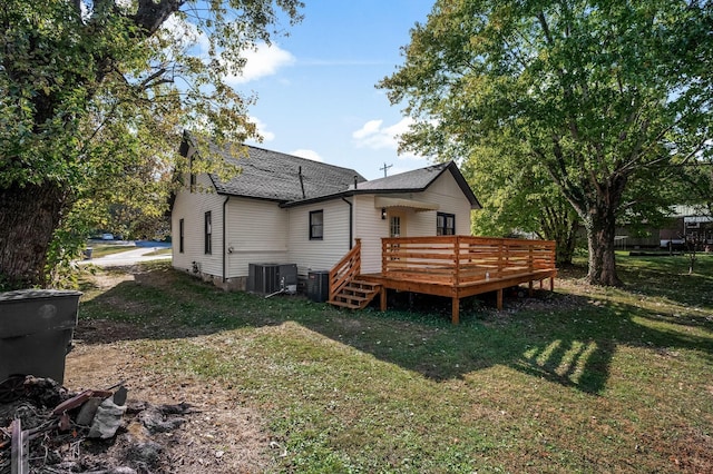 back of house with a wooden deck, central AC unit, and a lawn