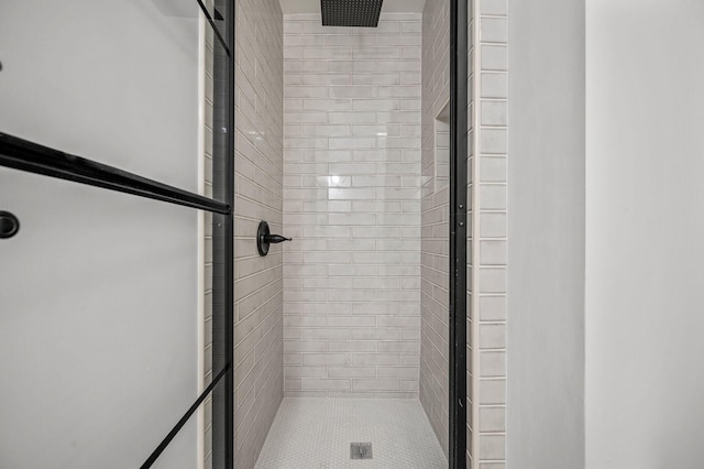 bathroom with a shower with door