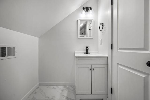 bathroom featuring vanity and vaulted ceiling