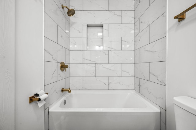 bathroom featuring toilet and tiled shower / bath combo