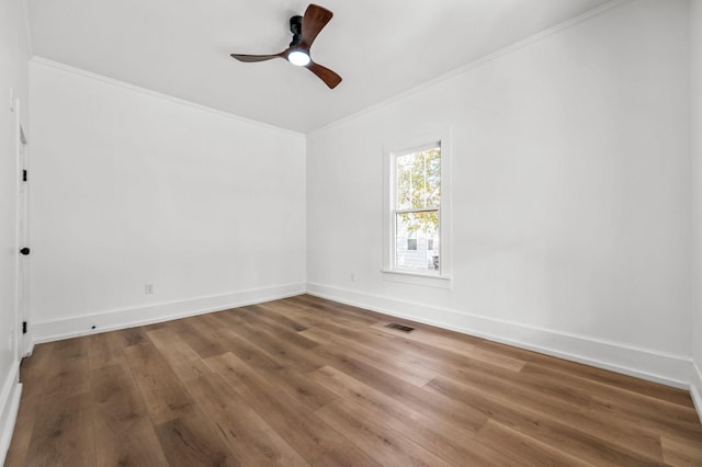 spare room with crown molding, ceiling fan, and hardwood / wood-style floors