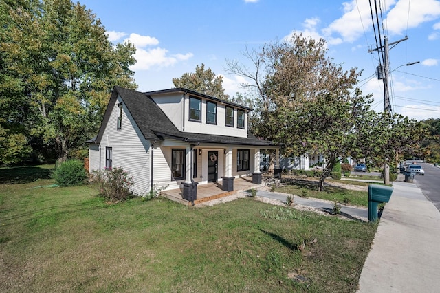 view of front of property featuring a porch and a front lawn