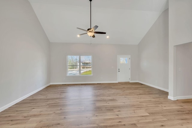 interior space featuring ceiling fan, high vaulted ceiling, and light hardwood / wood-style flooring