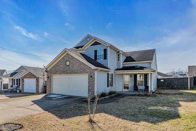 traditional home with a garage, concrete driveway, brick siding, and fence