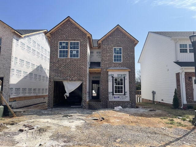 view of front of property with an attached garage and brick siding