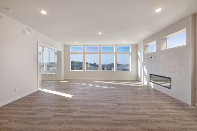 unfurnished living room with hardwood / wood-style floors