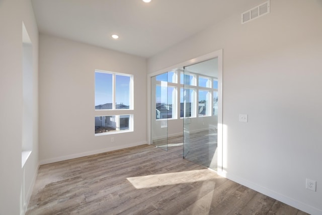 unfurnished room featuring light hardwood / wood-style floors