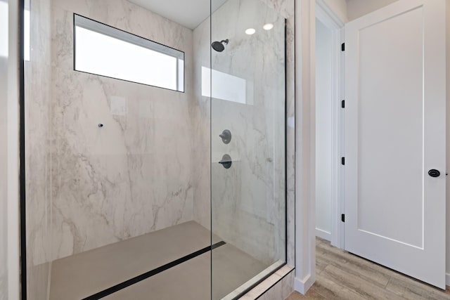 bathroom featuring tiled shower and hardwood / wood-style floors