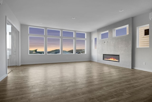 unfurnished living room featuring hardwood / wood-style flooring