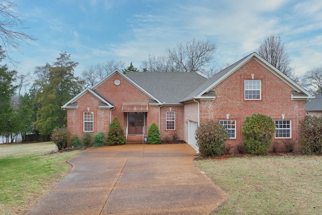 view of front of home featuring a garage and a front lawn