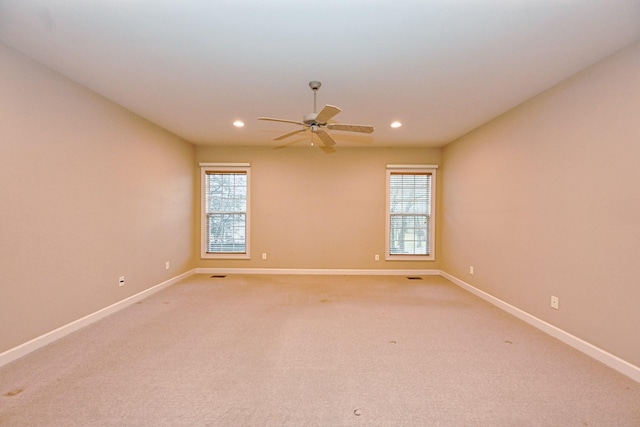 empty room featuring light carpet and ceiling fan