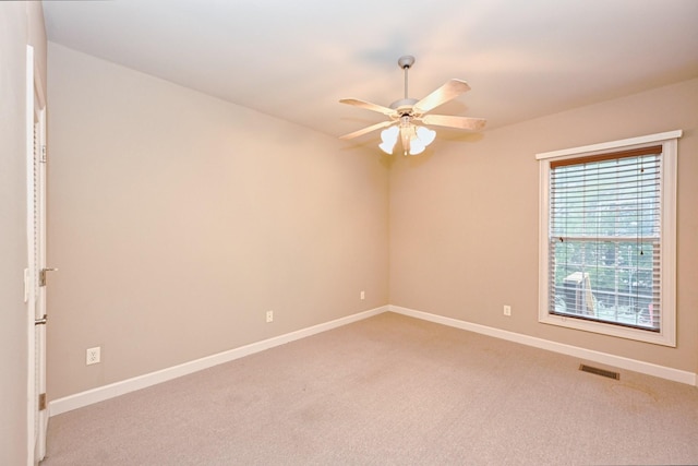 empty room featuring light carpet and ceiling fan