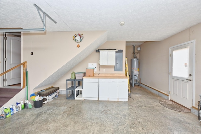 kitchen with a textured ceiling, electric panel, water heater, and white cabinets