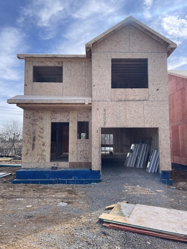 rear view of house featuring stucco siding