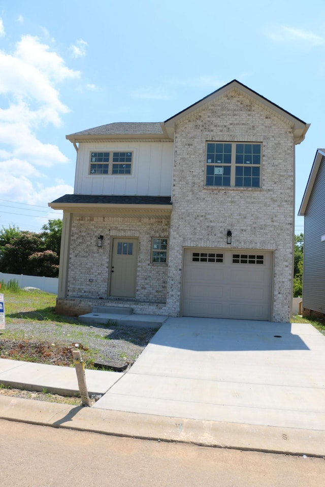 3 Charleston Cv, Clarksville, TN 37043 - view of front facade with board and batten siding, brick siding, driveway, and an attached garage