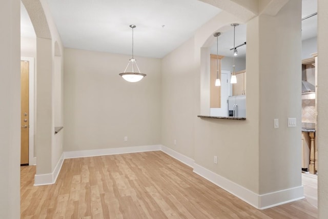 interior space featuring track lighting and light hardwood / wood-style flooring