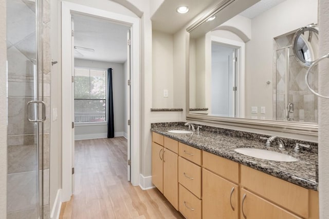 bathroom featuring vanity, hardwood / wood-style floors, and walk in shower