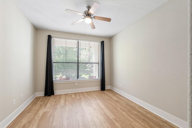 spare room with ceiling fan, a textured ceiling, and light hardwood / wood-style floors