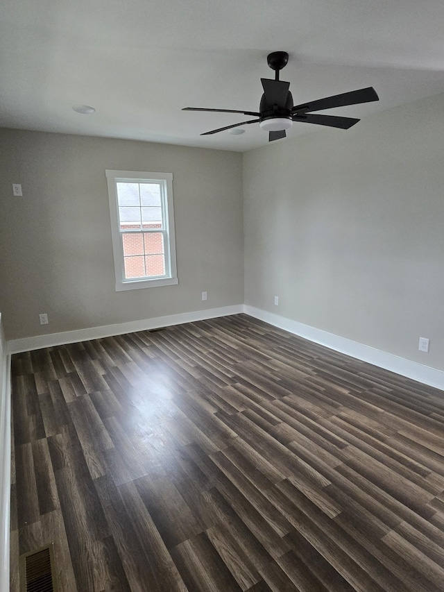 unfurnished room with dark wood-type flooring and ceiling fan