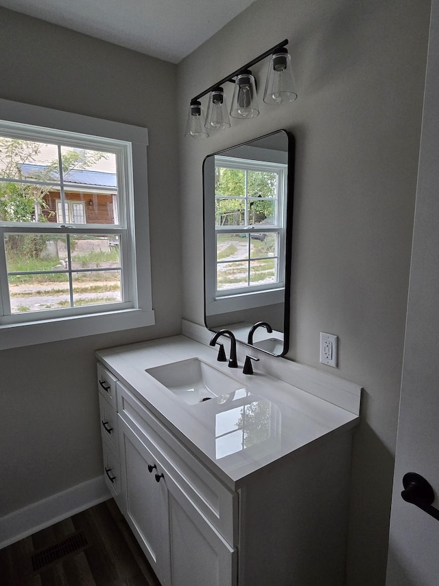 bathroom with vanity and hardwood / wood-style floors