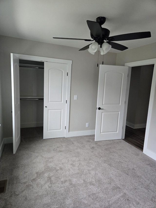 unfurnished bedroom with ceiling fan, a closet, and light carpet