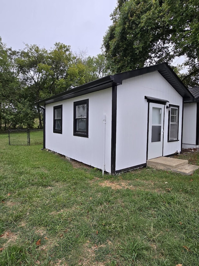 view of outdoor structure featuring a lawn