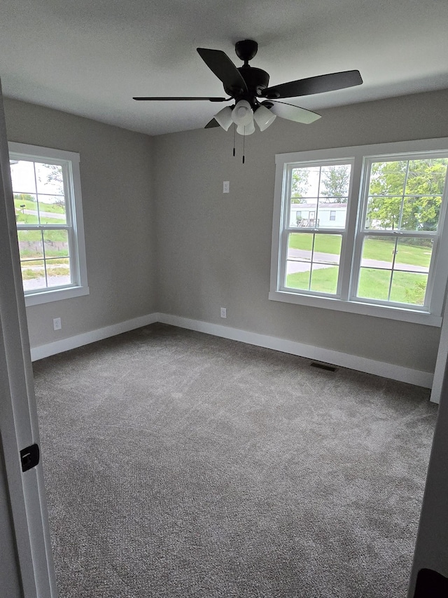 unfurnished room featuring carpet floors and ceiling fan