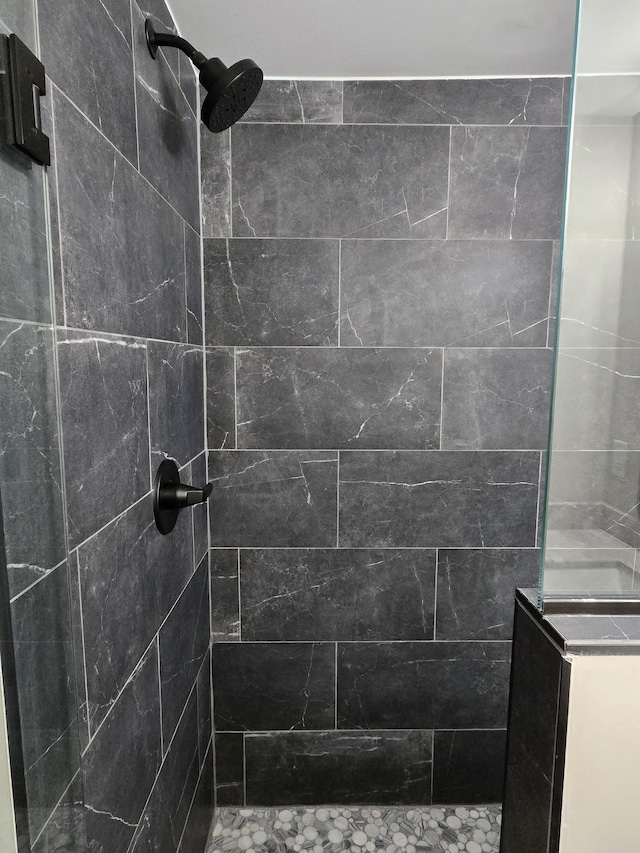 bathroom with a tile shower