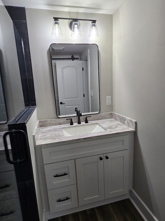 bathroom with vanity and hardwood / wood-style floors