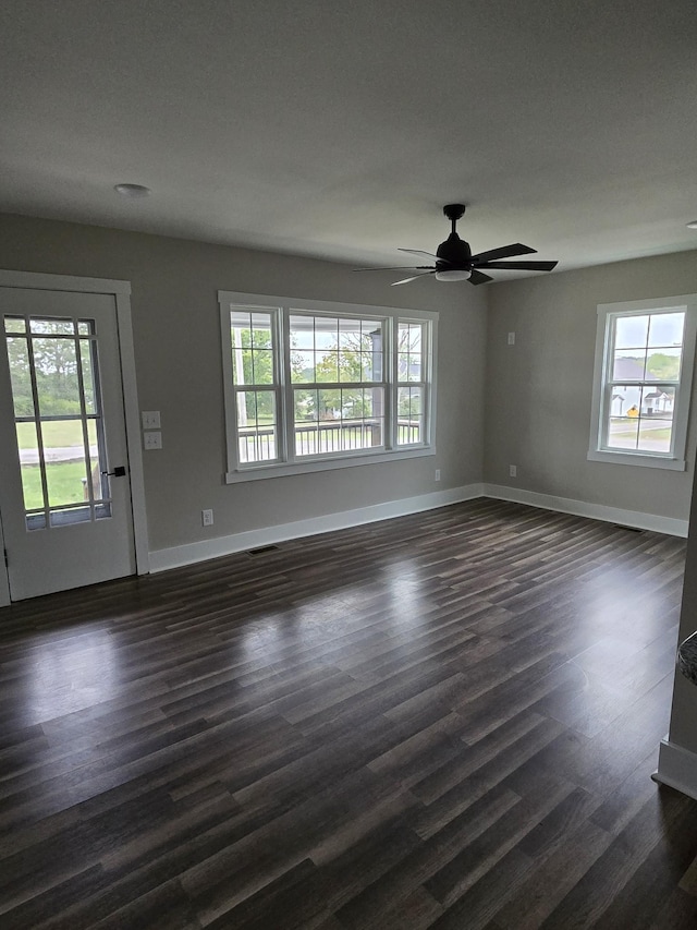 unfurnished living room featuring dark hardwood / wood-style floors and ceiling fan