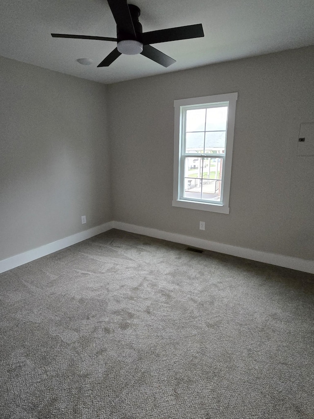 empty room with ceiling fan and carpet flooring